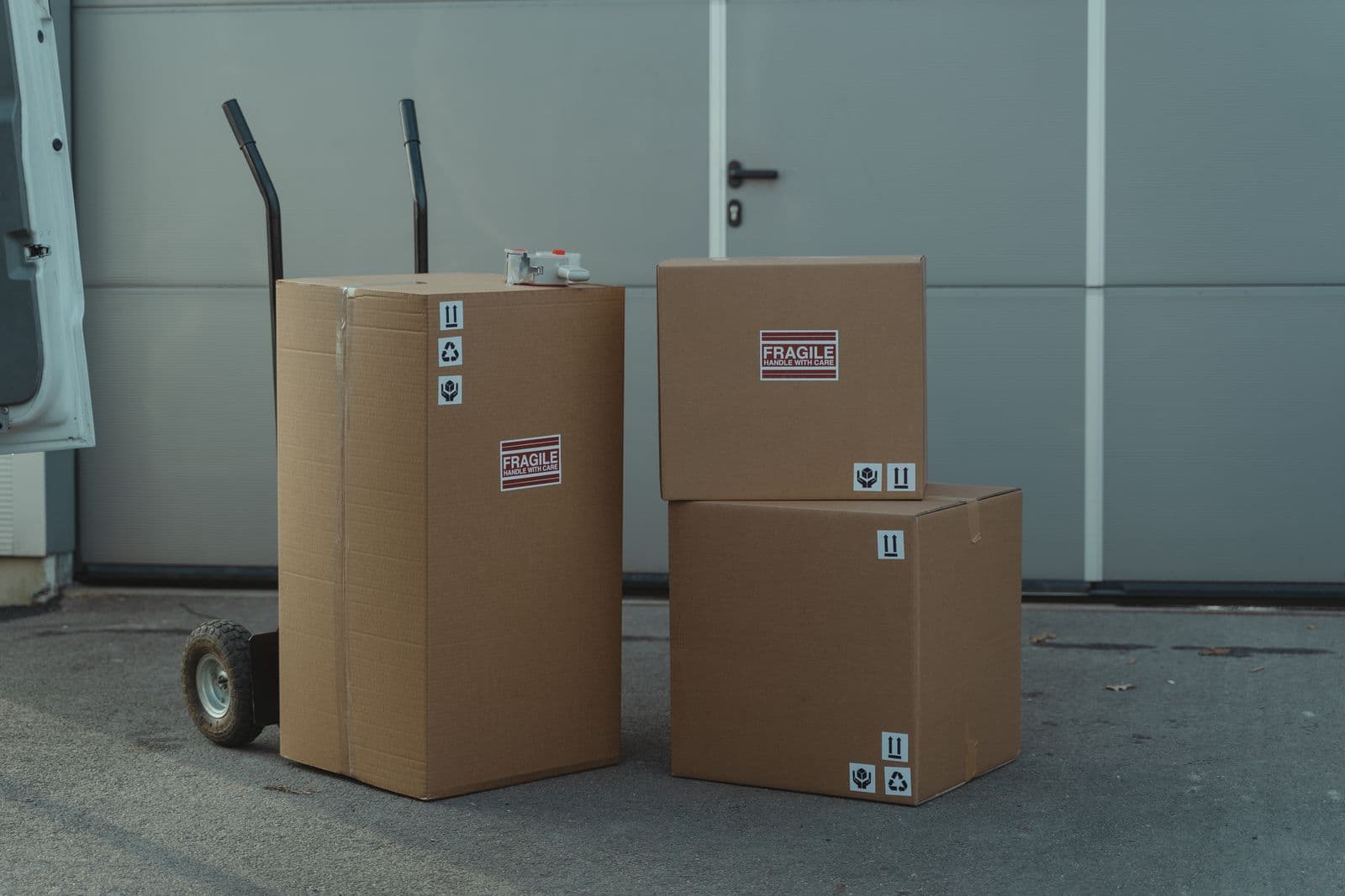Three cardboard shipping boxes on a hand truck